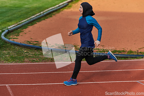 Image of A muslim woman in a burqa sports muslim clothes running on a marathon course and preparing for upcoming competitions