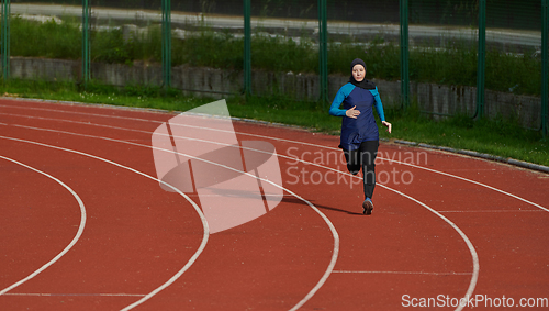 Image of A muslim woman in a burqa sports muslim clothes running on a marathon course and preparing for upcoming competitions