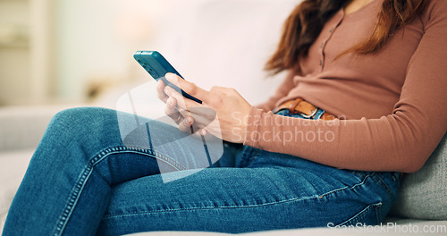 Image of Sofa, home and hands typing on smartphone chat, social media or networking connection on mobile app, internet or house wifi. Teenager girl or woman with cellphone technology texting message in lounge