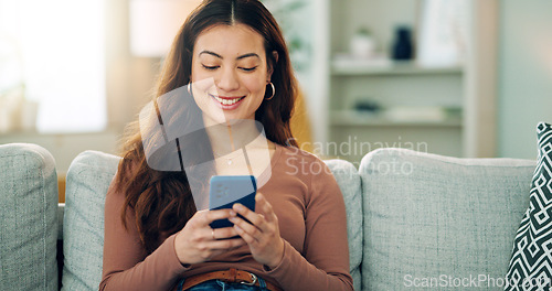 Image of Phone, social media and happy woman texting on a dating app and smiling on the weekend at home on the couch. Smile, chatting and young girl loves typing a message on a social networking website