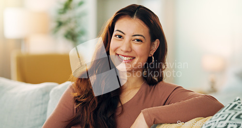 Image of Serious woman, relax and home with a beautiful asian female feeling calm, peaceful and enjoying her free time on the sofa at home. Portrait and face of a young female sitting in her singapore house