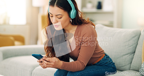 Image of Woman, phone or music headphones on relax sofa in house or Singaporean home living room. Smile,enjoy or happy student with mobile technology for podcast, dance radio or audio playlist app in lockdown