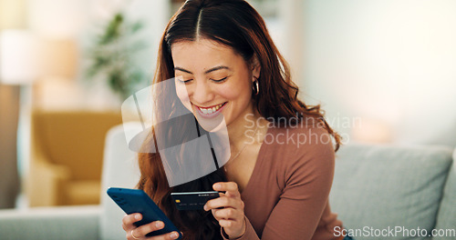 Image of Woman, phone or credit card for ecommerce, online shopping or bank app in Colombian house living room or home sofa. Smile, happy and relax customer on fintech technology or e commerce retail software