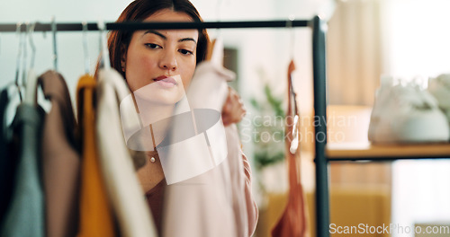 Image of Fashion, shopping and customer with a woman in a store for retail while looking at clothes to buy or purchase. Buying, consumerism and choice with a female purchaser in a clothing boutique or shop