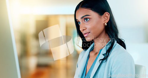 Image of Business woman reading information on a computer screen while working in an office. Closeup on face of one confident young entrepreneur and focused expert carefully analyzing ideas and plans online