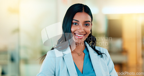 Image of Successful female executive typing or reading an email. Confident business woman using a computer at work. Selective focus on beautiful lady sitting in an office chair, smiling.