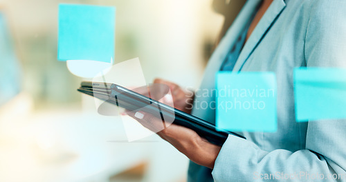 Image of Advertising agent scrolling for creative ideas online on the internet on a digital tablet while brainstorming alone in an office at work. One marketing worker doing research while planning a project