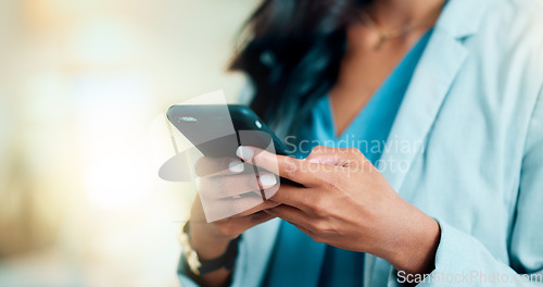 Image of Closeup of a woman texting, browsing and scrolling on a phone in an office. Hands of a corporate executive, busy entrepreneur and business expert typing a message while networking with clients online