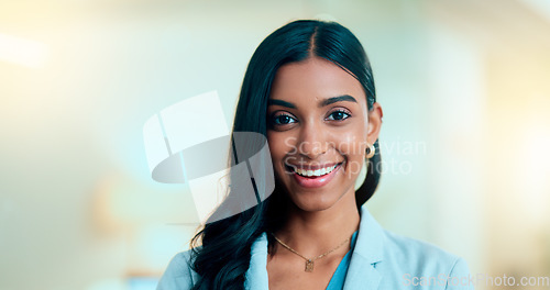 Image of Satisfied, confident entrepreneur doing an online training for a remote, distance job. Closeup face portrait of a successful business woman standing and smiling against a bokeh, copyspace background.