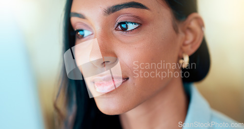 Image of Business woman reading information on a computer screen while working in an office. Closeup on face of one confident young entrepreneur and focused expert carefully analyzing ideas and plans online