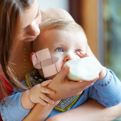 Image of Nurtured. Loved. Fed. Enough said. Shot of a young mother bottle-feeding her baby boy.