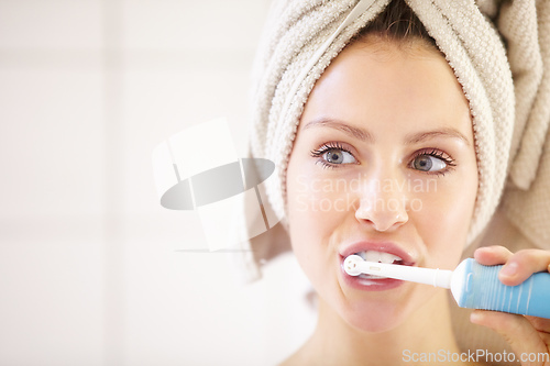 Image of Keeping her teeth in great shape - Dental hygiene. Cropped shot of an attractive young woman brushing her teeth.