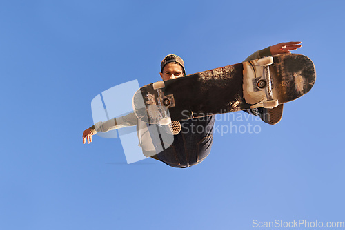 Image of Have you see the skills on this one. A young man doing tricks on his skateboard at the skate park.