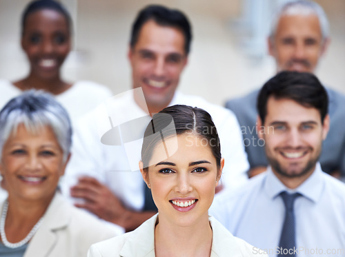 Image of I lead by example. Portrait of a smiling businesswoman surrounded by a group of her colleagues.