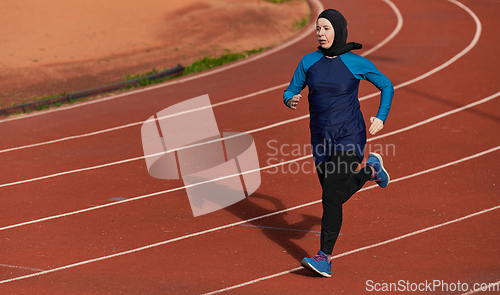 Image of A muslim woman in a burqa sports muslim clothes running on a marathon course and preparing for upcoming competitions