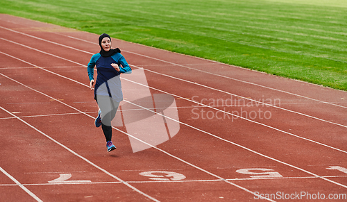 Image of A muslim woman in a burqa sports muslim clothes running on a marathon course and preparing for upcoming competitions