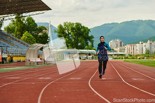 Image of A muslim woman in a burqa sports muslim clothes running on a marathon course and preparing for upcoming competitions