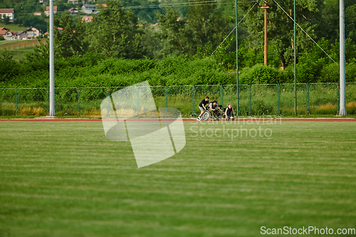 Image of A cameraman filming the participants of the Paralympic race on the marathon course