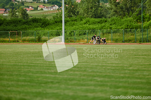 Image of A cameraman filming the participants of the Paralympic race on the marathon course