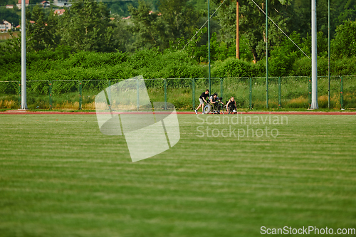 Image of A cameraman filming the participants of the Paralympic race on the marathon course