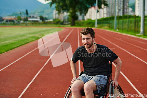 Image of A person with disability in a wheelchair training tirelessly on the track in preparation for the Paralympic Games