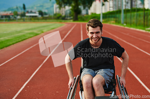 Image of A person with disability in a wheelchair training tirelessly on the track in preparation for the Paralympic Games