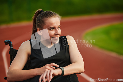 Image of A woman with disability in a wheelchair checking a smart watch after a quick workout