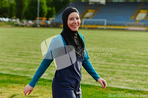 Image of A Muslim woman with a burqa, an Islamic sportswoman resting after a vigorous training session on the marathon course. A hijab woman is preparing for a marathon competition