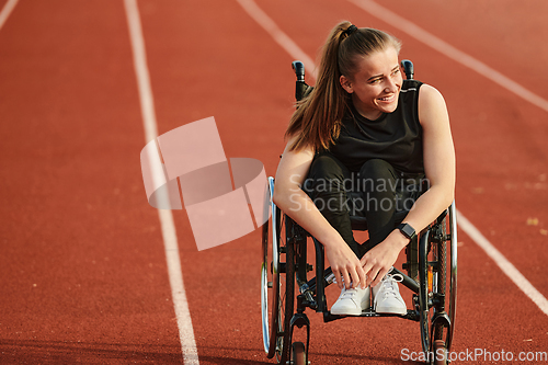 Image of A woman with disablity driving a wheelchair on a track while preparing for the Paralympic Games