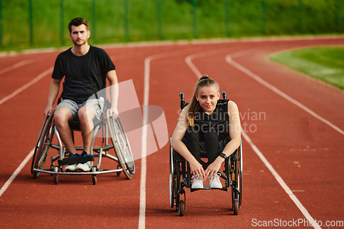 Image of An inspiring couple with disability showcase their incredible determination and strength as they train together for the Paralympics pushing their wheelchairs in marathon track