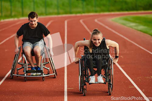Image of An inspiring couple with disability showcase their incredible determination and strength as they train together for the Paralympics pushing their wheelchairs in marathon track