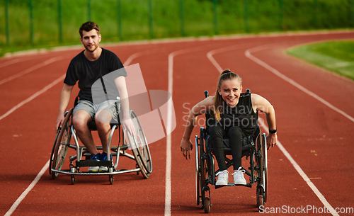 Image of An inspiring couple with disability showcase their incredible determination and strength as they train together for the Paralympics pushing their wheelchairs in marathon track