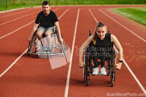 Image of An inspiring couple with disability showcase their incredible determination and strength as they train together for the Paralympics pushing their wheelchairs in marathon track