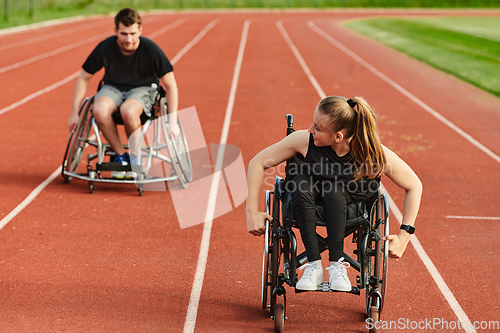 Image of An inspiring couple with disability showcase their incredible determination and strength as they train together for the Paralympics pushing their wheelchairs in marathon track