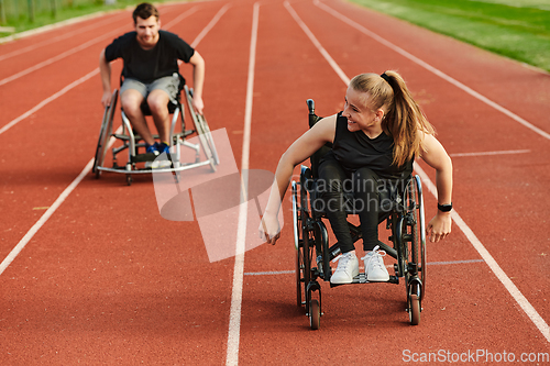 Image of An inspiring couple with disability showcase their incredible determination and strength as they train together for the Paralympics pushing their wheelchairs in marathon track