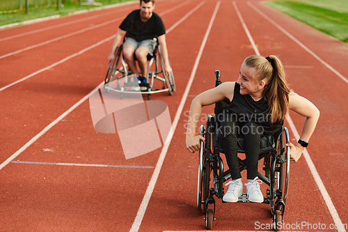 Image of An inspiring couple with disability showcase their incredible determination and strength as they train together for the Paralympics pushing their wheelchairs in marathon track