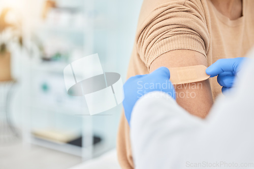 Image of Bandaid, vaccine and arm of patient with doctor for healthcare, medical consultation and bandage for covid injection. Hands, hospital nurse and plaster for an injury, virus or safety while sick