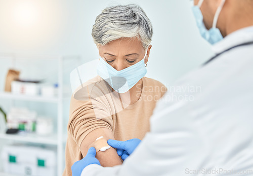 Image of Doctor, senior patient and plaster, vaccine and wound treatment, safety and face mask for health and Covid immunity. Healthcare, injection and bandage, people at hospital and protection from virus