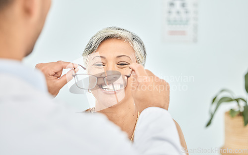 Image of Smile, glasses and hands of ophthalmologist on woman in hospital for vision, healthcare or wellness. Frame, optometrist and mature patient happy for eyewear, lens or prescription spectacles in clinic