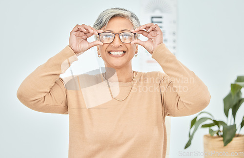 Image of Mature woman, portrait and glasses for vision eye, test and optometry in clinic wellness, choice and prescription frames. Person, smile and Mexican patient in store, shop and eyesight retail decision