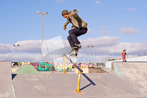 Image of Grinding like a pro. Shot of a skateboarder performing a trick on a rail.