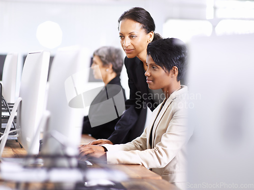 Image of They have the best equipment for the job. Shot of three businesswomen working in an office.