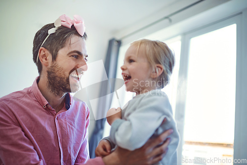 Image of His daughter fills his world with joy and laughter. Shot of a young man spending quality time with his adorable daughter at home.