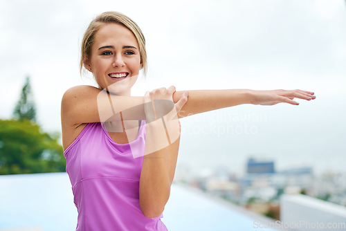 Image of Stretching myself towards a better lifestyle. Cropped shot of a young woman doing stretch exercises.