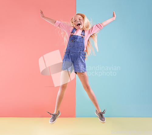 Image of Wheee. A cute little girl jumping against a colorful background.