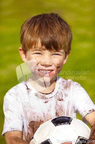 Image of Want to play. Portrait of a muddy little boy holding a soccer ball.