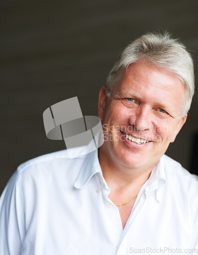 Image of Happy and confident. Cropped portrait of a senior man against a dark background.