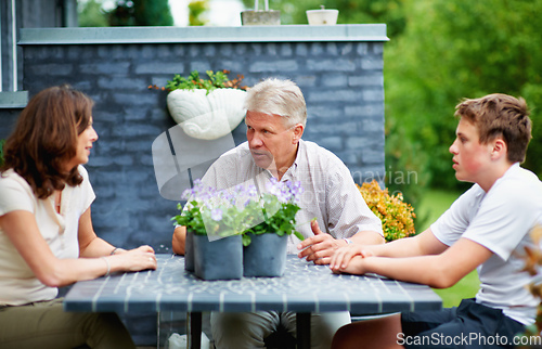 Image of Family bonding. Cropped shot of a senior couple sitting outside with their grandson.