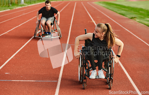 Image of An inspiring couple with disability showcase their incredible determination and strength as they train together for the Paralympics pushing their wheelchairs in marathon track