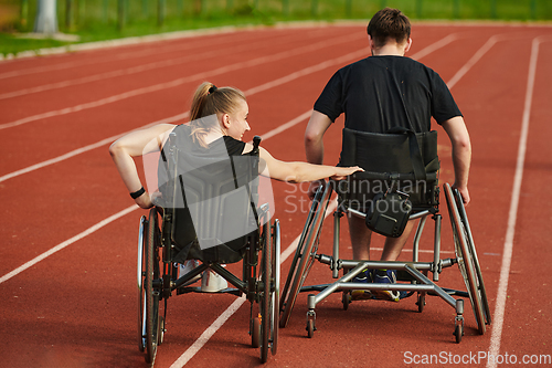 Image of An inspiring couple with disability showcase their incredible determination and strength as they train together for the Paralympics pushing their wheelchairs in marathon track